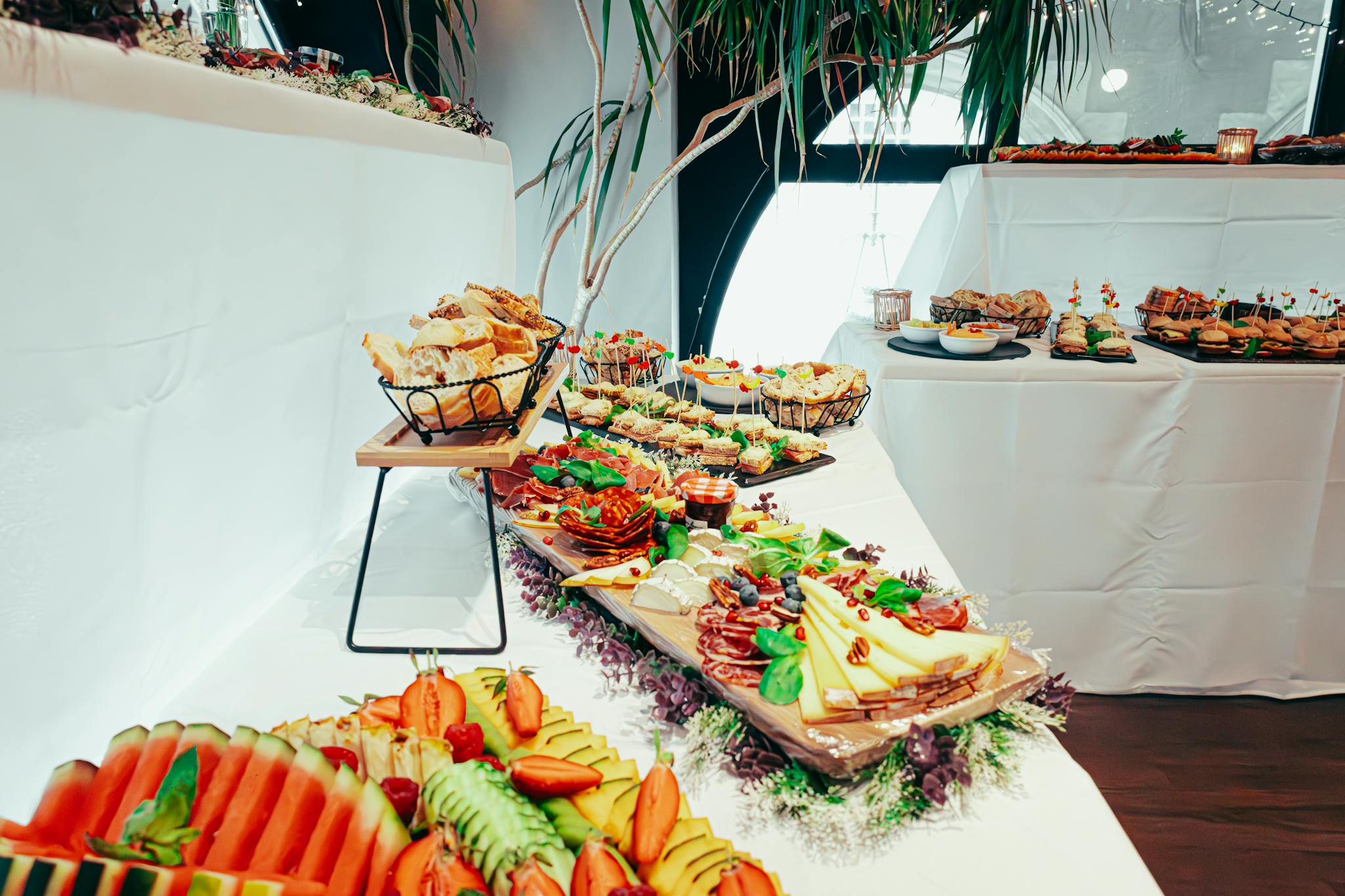 Beautifully arranged buffet table with assorted foods and elegant presentation, perfect for weddings or special events.