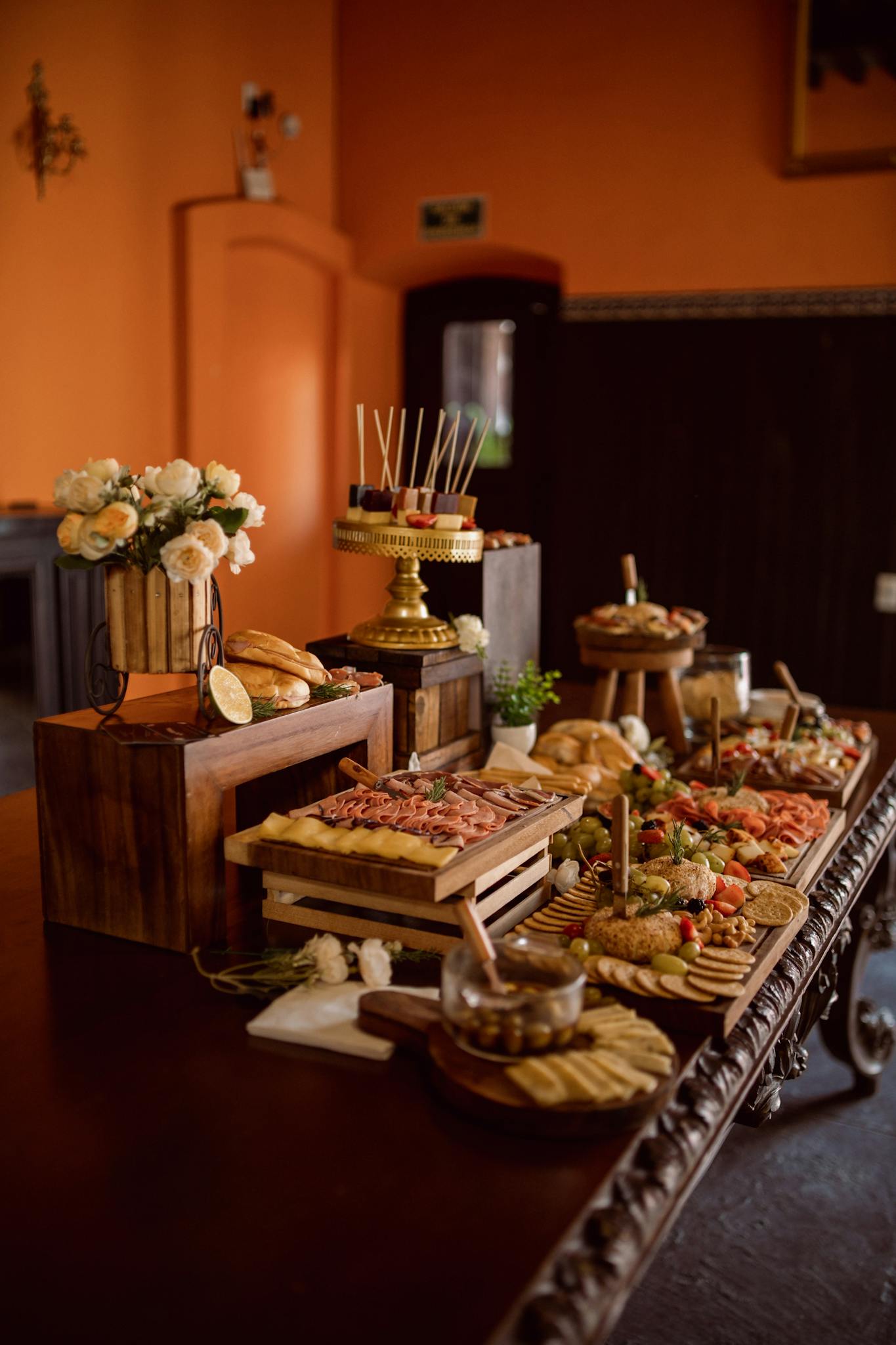 Beautifully arranged event table featuring appetizers, flowers, and elegant decor.