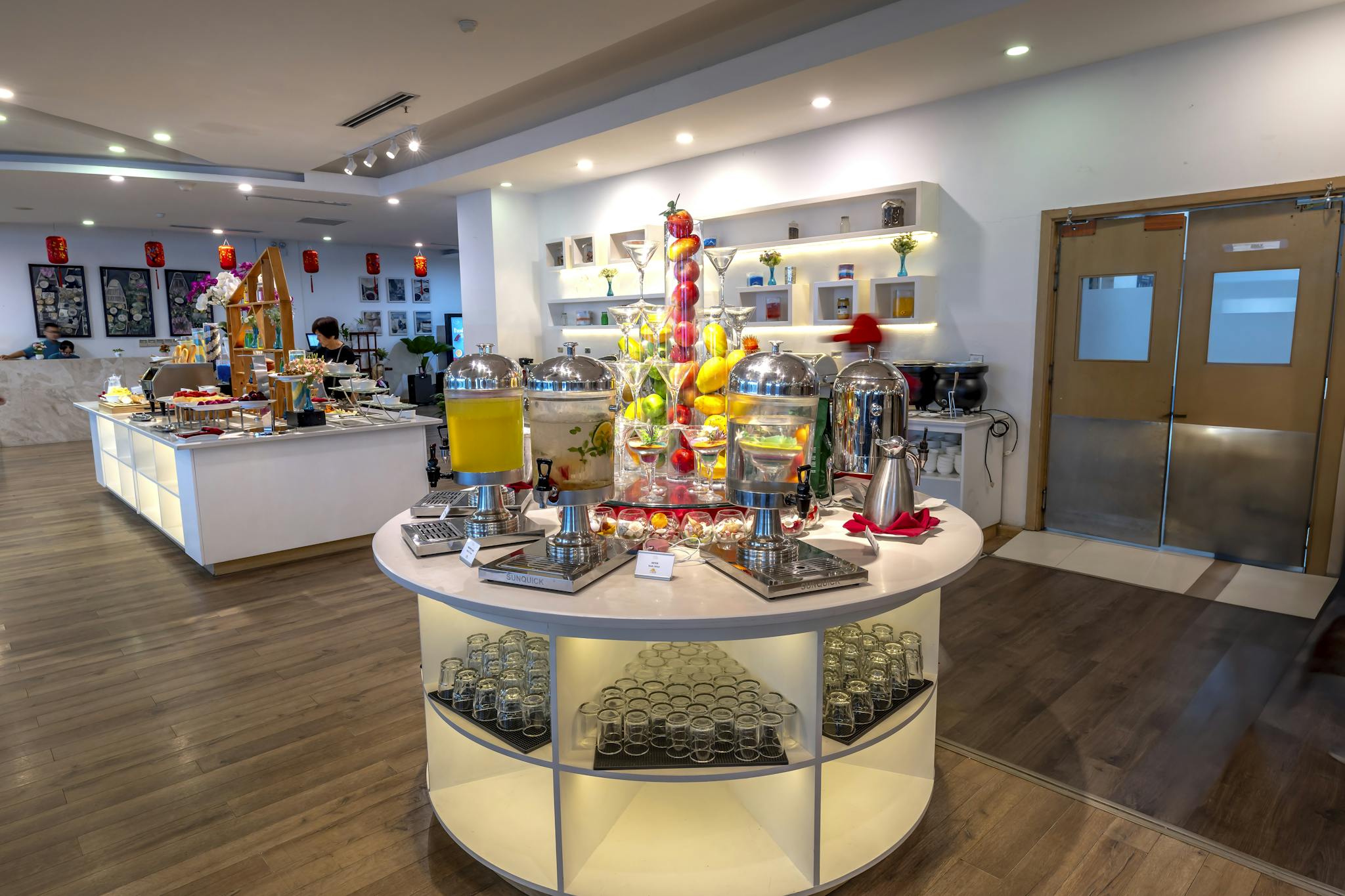 Luxurious buffet display with diverse food and beverages in a modern hotel setting.